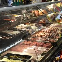 Italian deli counter case with cured meats and sausages at Monte Carlo